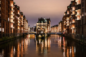 Hamburg Speicherstadt at night, Wasserschloss, buildings with reflection in water