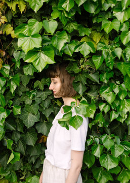 Portraits of girl surrounded by ivy