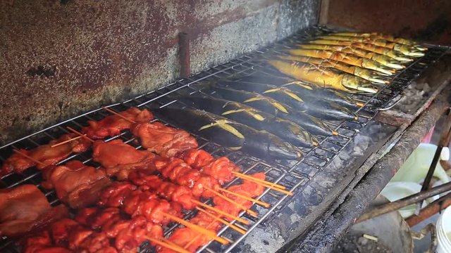 Street thai food : grilled sea fish on the night food market in island Koh Phangan, Thailand. Close up