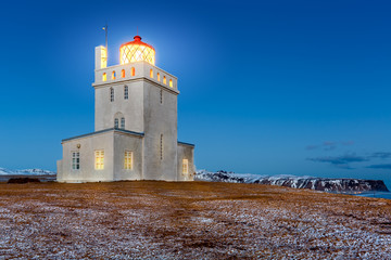 Fototapeta na wymiar Dyrholaey lighthouse at dusk. The light station at Dyrholaey was established in 1910, near the village Vik, on the southern tip of Iceland.