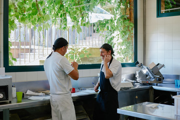 Two cooks talking in a relax moment in the kitchen