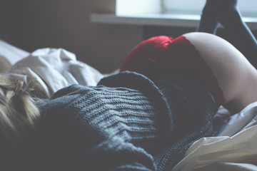 Beautiful naked girl in the grey sweater and red panties.