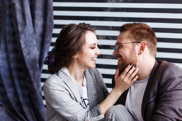 Beautiful couple hugging and talking. Deep feelings, love, affection. Close trusting relationship between a man and a woman. Close portrait in studio