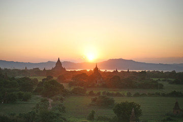 The sun sets over the plains of Bagan, framing the pagodas and stupas in the golden light