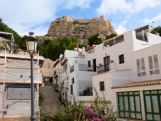 climb to the castle of Santa Barbara among the white houses of the old district of Alicante, Spain
