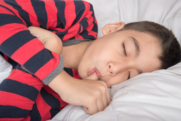 Little boy sleeping with thumb in the mouth