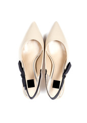 Women's Kitten Heel Dress Shoes in Beige Color Decorated with Black Bow Isolated on White