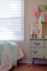 Girls bedroom decor with vintage dresser in pastel mint green