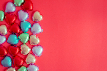Red background with multicolored heart rests in the concept of Valentine's Day.