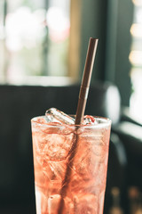 Glass of iced berry soda on the table.
