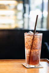 Glass of iced berry soda on the table.