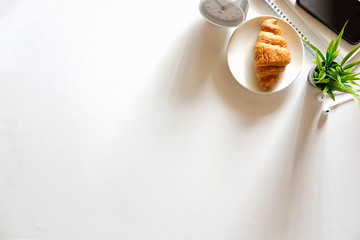 Office desk table with snack, supplies and coffee cup