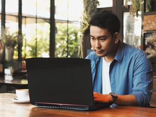 Business man working with laptop at coffee shop.