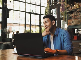 Business man working with laptop at coffee shop.