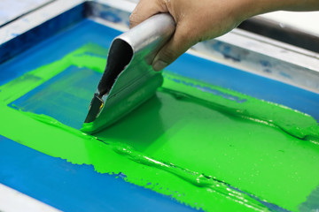 Hand pressing silk-screen printing, close up view.