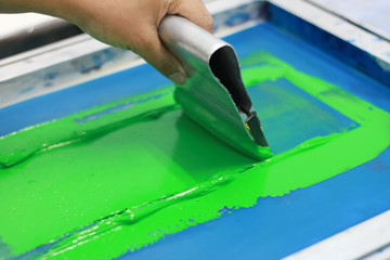 Hand pressing silk-screen printing, close up view.