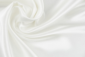 The texture of the satin fabric of white color for the background  