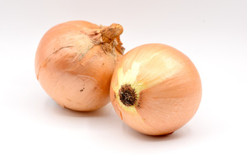 White onions with orange skin on a seamless white background. 
