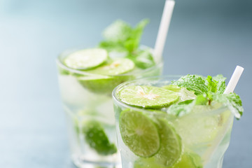 Glass of iced lemonade soda with slice lemon and mint leaves, cold drink in summer