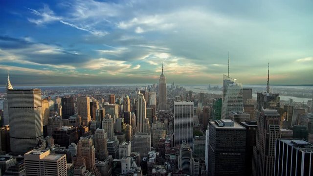 Empire State Building and skyscrapers in Manhattan cityscape from high view - 24 hour time-lapse with seamless loop - New York City NYC in 4K and 1080 HD