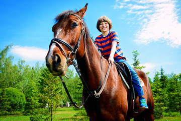 boy is riding horse