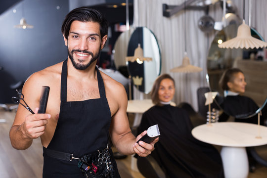 professional male hairdresser with visitor