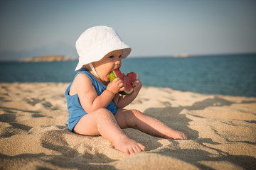 Happy child on sea with watermelon