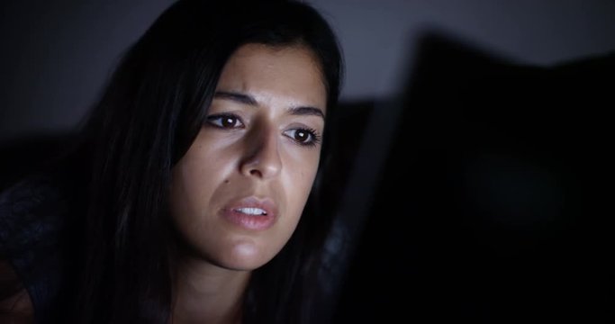 4K Woman checking her social media at night, upset by what she sees on screen