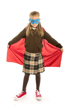 7 or 8 years old young female child in super hero costume over school uniform  performing happy and excited isolated on white background
