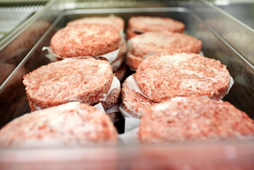 Metal tray of frozen hamburger patties