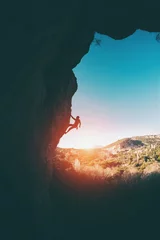 Foto op Plexiglas Silhouette of a climber. © zhukovvvlad