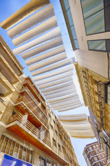 strips of fabric provide protection from the sun in the streets of cordoba spain