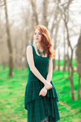 Fototapeta premium redhead girl in green dress in the park