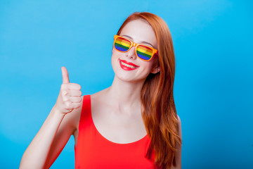 Redhead girl with rainbow sunglasses