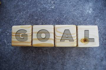Goal Text On Wooden Block on grey background.