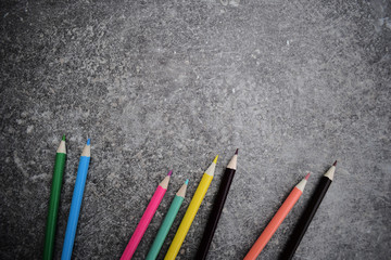 Eight color pencils on grey background. Colored drawing pencils.
