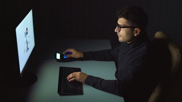 The person working with a 3d graphics in a computer. night time