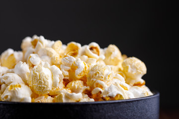 Aerial and mouth-watering popcorn in a ceramic bowl.