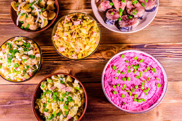 Different festive dishes on a wooden table. Top view