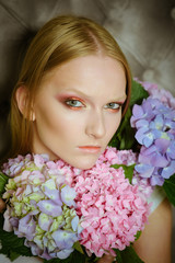 Young beauty woman, blond hair with hydrangea
