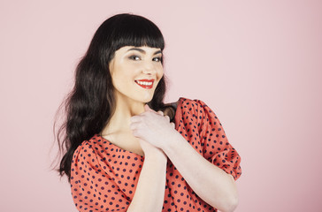 Happy girl with cheerful face isolated on pink background.