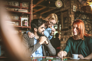 Three young people playing leisure game.