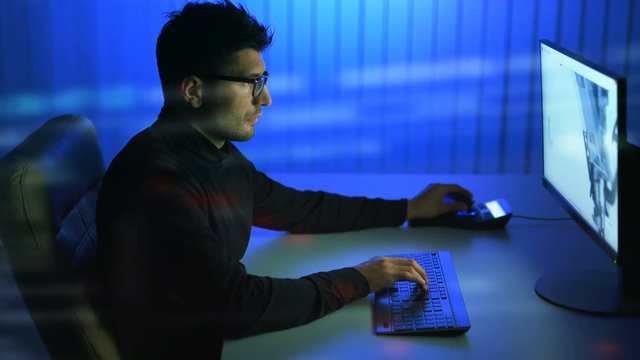 The man working with a 3d modeling over the virtual glass. evening night time