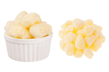 Set of sweet yellow corn sticks with powdered sugar as heap and in ceramics bowl isolated on white background. Fast food template for menu, advertising, cover.