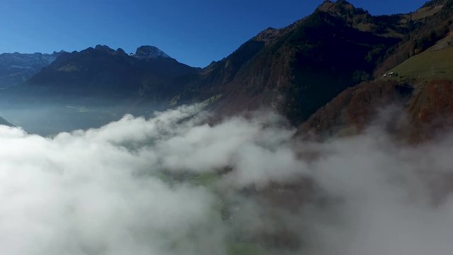 Aerial view in the valley of Engelberg in the foothills of Switzerland on an autumn day with a sea of fog