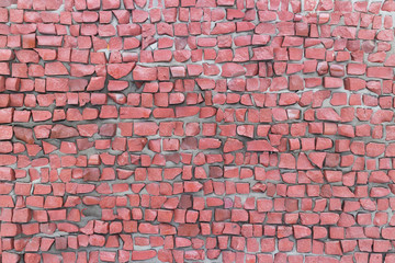 Orange tea rose smalt pebbles on gray cement wall