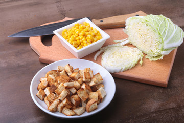 Fresh Chinese cabbage, Sweet canned corn, Delicious crispy croutons and canned tuna. Ingredients for dietary salad.