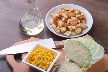 Fresh Chinese cabbage, Sweet canned corn, Delicious crispy croutons and canned tuna. Ingredients for dietary salad.