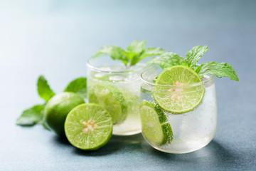 Glass of iced lemonade soda with slice lemon and mint leaves, cold drink in summer