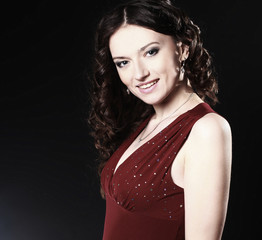 portrait of beautiful woman in red dress posing for the camera